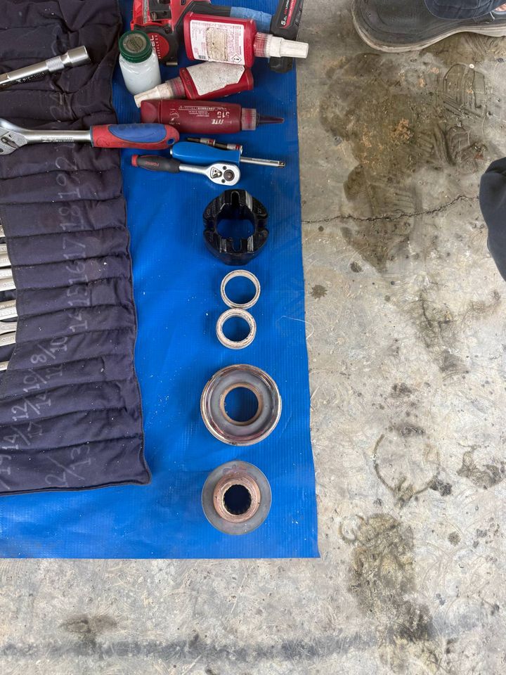 Tools and fittings laid out on a blue mat